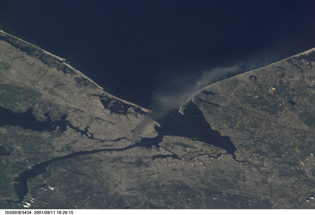 One of a series of pictures taken of metropolitan New York City (and other parts of New York as well as New Jersey) by one of the Expedition Three crew members onboard the International Space Station (ISS) at various times during the day of September 11, 2001. The image shows a smoke plume rising from the Manhattan area. The orbital outpost was flying at an altitude of approximately 250 miles. The image was recorded with a digital still camera. Please note: The date identifiers on some frames (other than those that indicate Sept. 11, 2001) are not accurate due to a technical problem with one of the Expedition Three cameras.