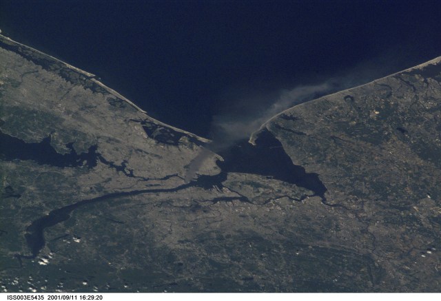 One of a series of pictures taken of metropolitan New York City (and other parts of New York as well as New Jersey) by one of the Expedition Three crew members onboard the International Space Station (ISS) at various times during the day of September 11, 2001. The image shows a smoke plume rising from the Manhattan area. The orbital outpost was flying at an altitude of approximately 250 miles. The image was recorded with a digital still camera. Please note: The date identifiers on some frames (other than those that indicate Sept. 11, 2001) are not accurate due to a technical problem with one of the Expedition Three cameras.