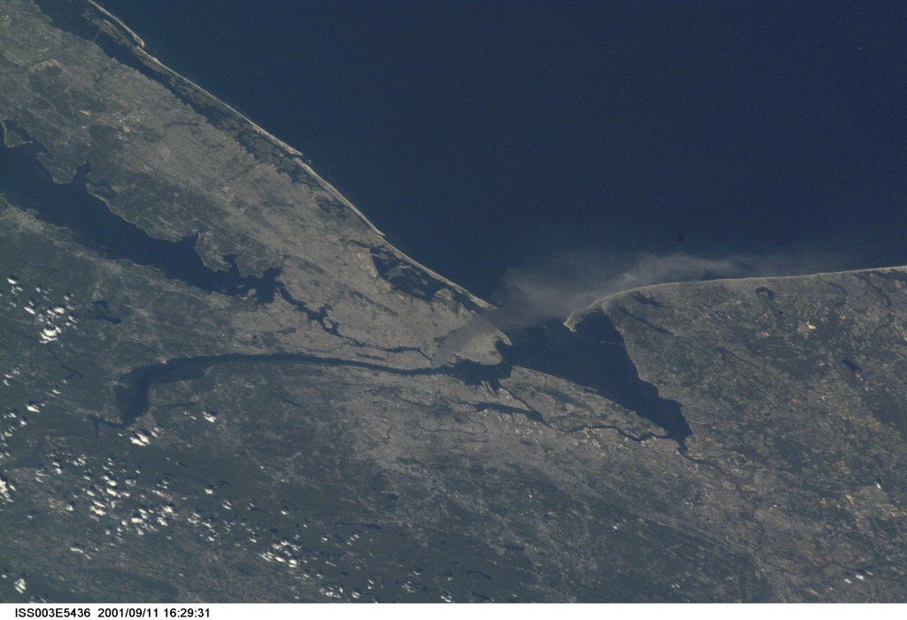 One of a series of pictures taken of metropolitan New York City (and other parts of New York as well as New Jersey) by one of the Expedition Three crew members onboard the International Space Station (ISS) at various times during the day of September 11, 2001. The image shows a smoke plume rising from the Manhattan area. The orbital outpost was flying at an altitude of approximately 250 miles. The image was recorded with a digital still camera. Please note: The date identifiers on some frames (other than those that indicate Sept. 11, 2001) are not accurate due to a technical problem with one of the Expedition Three cameras.
