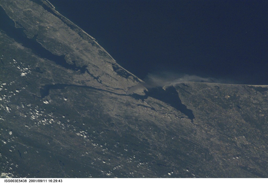 One of a series of pictures taken of metropolitan New York City (and other parts of New York as well as New Jersey) by one of the Expedition Three crew members onboard the International Space Station (ISS) at various times during the day of September 11, 2001. The image shows a smoke plume rising from the Manhattan area. The orbital outpost was flying at an altitude of approximately 250 miles. The image was recorded with a digital still camera. Please note: The date identifiers on some frames (other than those that indicate Sept. 11, 2001) are not accurate due to a technical problem with one of the Expedition Three cameras.