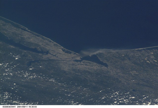 One of a series of pictures taken of metropolitan New York City (and other parts of New York as well as New Jersey) by one of the Expedition Three crew members onboard the International Space Station (ISS) at various times during the day of September 11, 2001. The image shows a smoke plume rising from the Manhattan area. The orbital outpost was flying at an altitude of approximately 250 miles. The image was recorded with a digital still camera. Please note: The date identifiers on some frames (other than those that indicate Sept. 11, 2001) are not accurate due to a technical problem with one of the Expedition Three cameras.