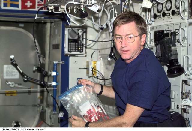 Astronaut Frank L. Culbertson, Expedition Three mission commander, holds a syringe kit to be used in the Quad Tissue Culture Module Assemblies (QTCMA) for the Biotechnology Specimen Temperature Controller (BSTC) experiment in the U.S. Laboratory.