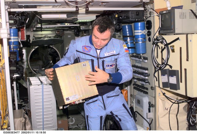 Cosmonaut Vladimir Dezhurov of Rosaviakosmos, Expedition Three flight engineer, holds a Global Time System (GTS) electronics unit in the Zvezda Service Module. Please note: The date identifiers on some frames are not accurate due to a technical problem with one of the Expedition Three cameras. When a specific date is given in the text or description portion, it is correct.