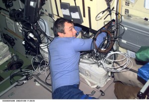 Cosmonaut Vladimir Dezhurov of Rosaviakosmos, Expedition Three flight engineer, works on electronic equipment behind a panel in the Zvezda Service Module. Please note: The date identifiers on some frames are not accurate due to a technical problem with one of the Expedition Three cameras. When a specific date is given in the text or description portion, it is correct.