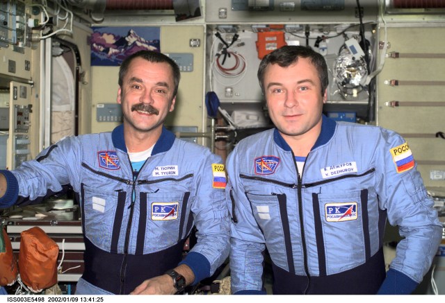 Cosmonauts Mikhail Tyurin (left) and Vladimir Dezhurov, Expedition Three flight engineers, pose for a photograph in the Zvezda Service Module. Tyurin and Dezhurov represent Rosaviakosmos. Please note: The date identifiers on some frames are not accurate due to a technical problem with one of the Expedition Three cameras. When a specific date is given in the text or description portion, it is correct.