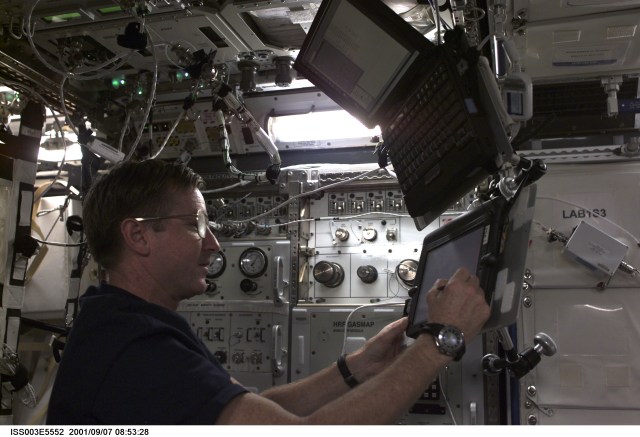 Astronaut Frank L. Culbertson, Jr., Expedition Three mission commander, uses a Personal Data Assistant (PDA) in the U.S. Laboratory.
