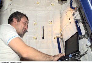 Cosmonaut Vladimir Dezhurov of Rosaviakosmos, Expedition Three flight engineer, works on a laptop computer in the Temporary Sleep Station (TSS) in the U.S. Laboratory.