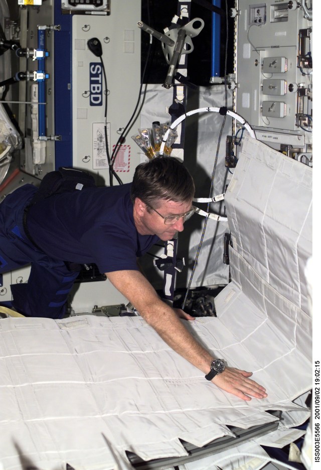 Astronaut Frank L. Culbertson, Jr., Expedition Three mission commander, assembles the Temporary Sleep Station (TESS) in the U.S. Laboratory.