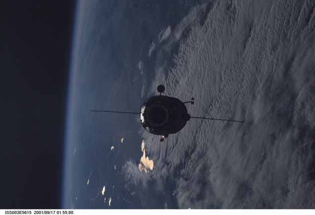 Appearing almost as a silhouette against Earth, the Russian Docking Compartment, named Pirs (the Russian word for pier), approaches the International Space Station (ISS). One of the Expedition Three crew members, using a digital still camera with a 70mm lens, recorded the image from onboard the orbital outpost. The vehicle was launched on September 14, 2001 and docking occurred on September 16.