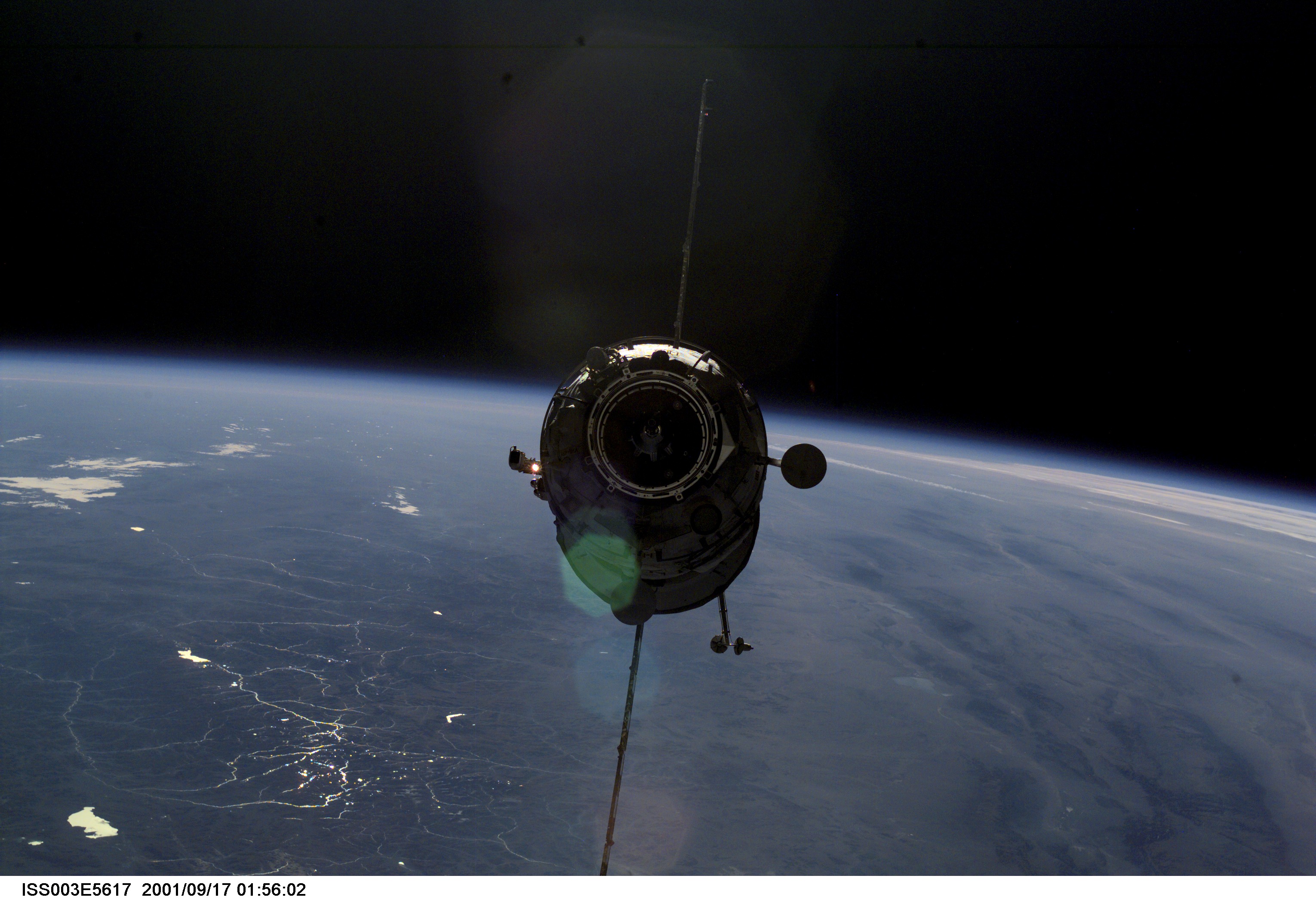 Appearing almost as a silhouette backdropped against Earth's horizon, the Russian Docking Compartment, named Pirs (the Russian word for pier), approaches the International Space Station (ISS). One of the Expedition Three crew members, using a digital still camera with a 70mm lens, recorded the image from onboard the orbital outpost. The vehicle was launched on September 14, 2001 and docking occurred on September 16.