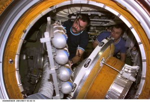 Cosmonaut Mikhail Tyurin (left) and Cosmonaut Vladimir Dezhurov, Expedition Three flight engineers, remove the docking probe in the Zvezda Service Module's transfer compartment. The docking probe successfully guided the arrival of the Russian built Pirs docking compartment to the International Space Station (ISS). Tyurin and Dezhurov represent Rosaviakosmos.