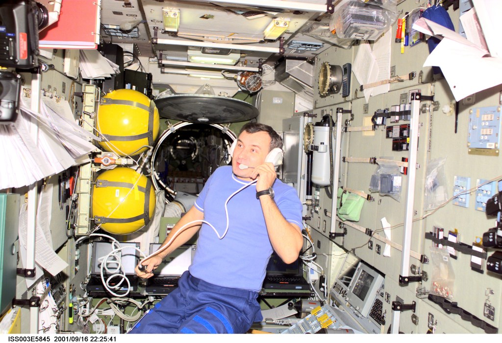 Cosmonaut Vladimir N. Dezhurov, Expedition Three flight engineer representing Rosaviakosmos, talks with flight controllers from the Zvezda Service Module on the International Space Station (ISS). This image was taken with a digital still camera.