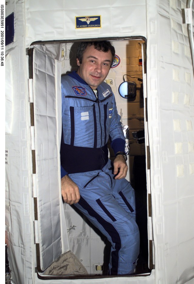 Cosmonaut Vladimir N. Dezhurov, Expedition Three flight engineer, takes a break from a busy day in the Temporary Sleep Station (TSS) in the Destiny laboratory on the International Space Station (ISS). Dezhurov represents Rosaviakosmos. This image was taken with a digital still camera.