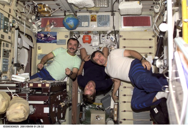 The Expedition Three crew members assemble for a crew photo in the Zvezda Service Module of the International Space Station (ISS). Astronaut Frank L. Culbertson, Jr. (center) is the Expedition Three commander. Culbertson is flanked by cosmonauts Mikhail Tyurin (left) and Vladimir Dezhurov, both flight engineers representing Rosaviakosmos. This picture was taken with a digital still camera.