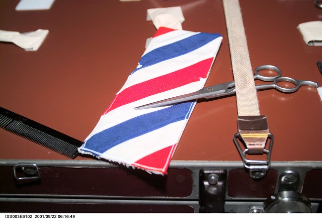 This close-up view shows some barber’s paraphernalia used by the Expedition Three crew to cut one another’s hair on the International Space Station (ISS). The crew even thought to include a makeshift barber pole. This picture was taken with a digital still camera.