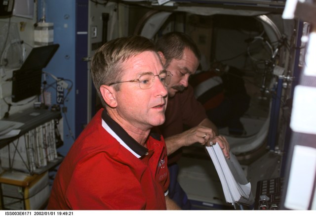 Astronaut Frank L. Culbertson, Jr., Expedition Three mission commander, and cosmonaut Mikhail Tyurin, flight engineer, perform routine maintenance in the Destiny laboratory on the International Space Station (ISS). Tyurin represents Rosaviakosmos. This image was taken with a digital still camera.