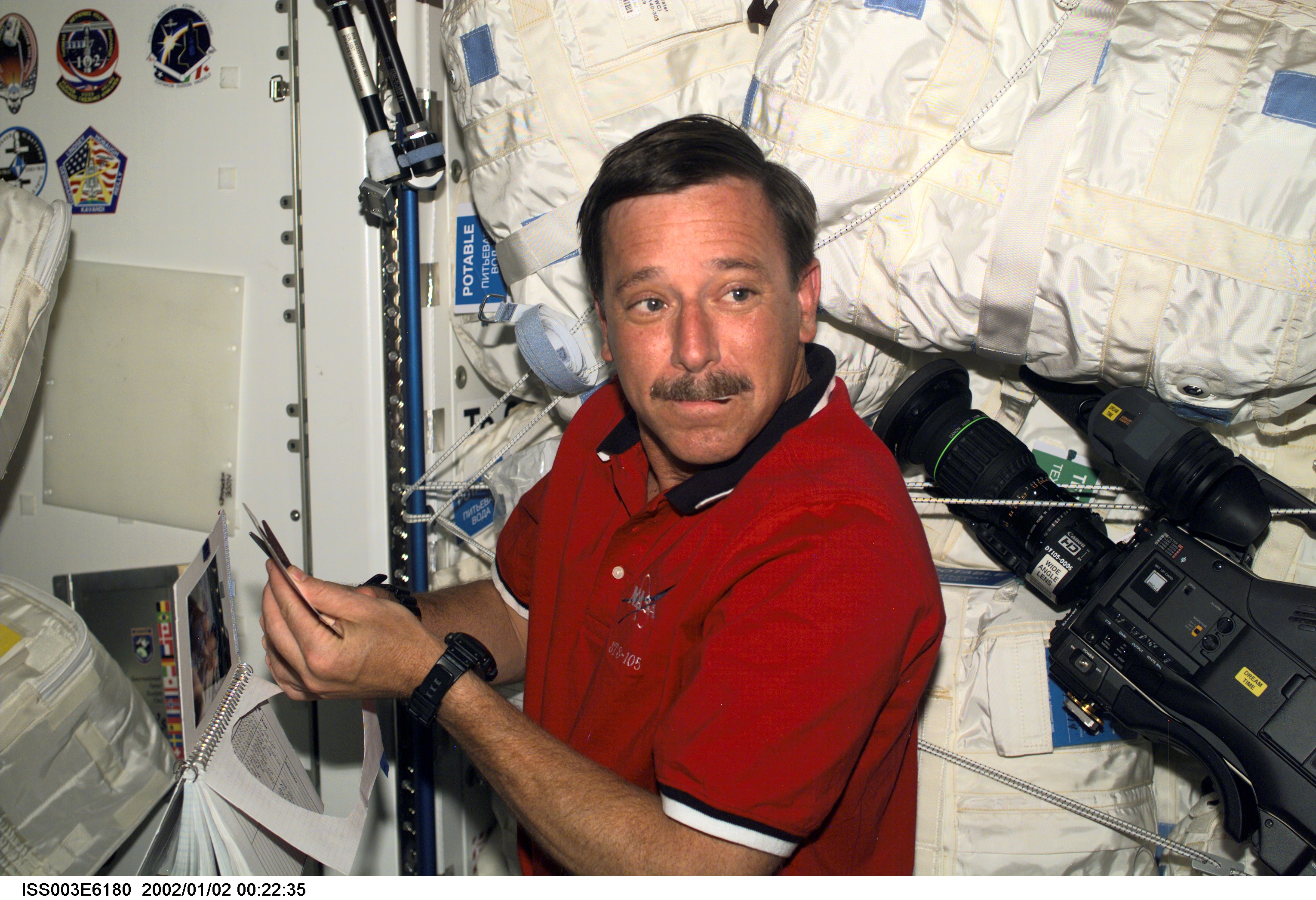 Astronaut Scott J. Horowitz, STS-105 mission commander, prepares the STS-105 crew patch to be added to the growing collection of those representing Shuttle crews who have worked on the International Space Station (ISS). Horowitz is located in the Unity node of the ISS. This image was taken with a digital still camera.