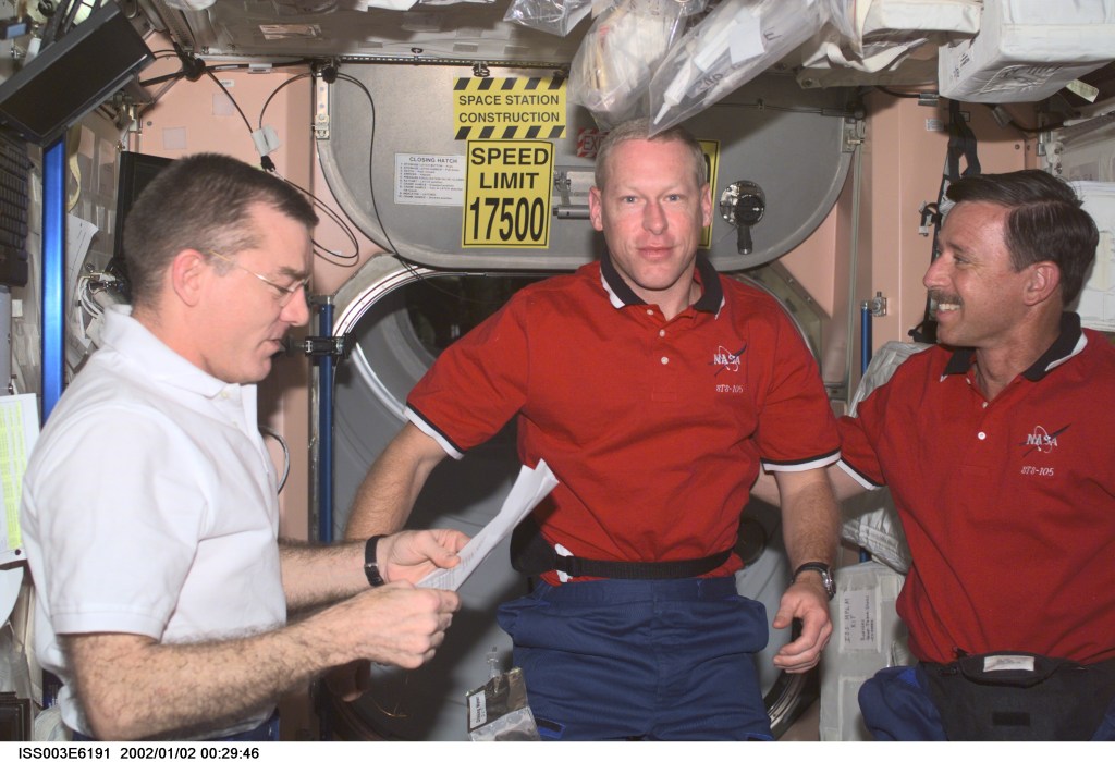 Astronauts James S. Voss (left), Expedition Two flight engineer, Patrick G. Forrester, STS-105 mission specialist, and Scott J. Horowitz, mission commander, are photographed in the Unity node on the International Space Station (ISS). This image was taken with a digital still camera.