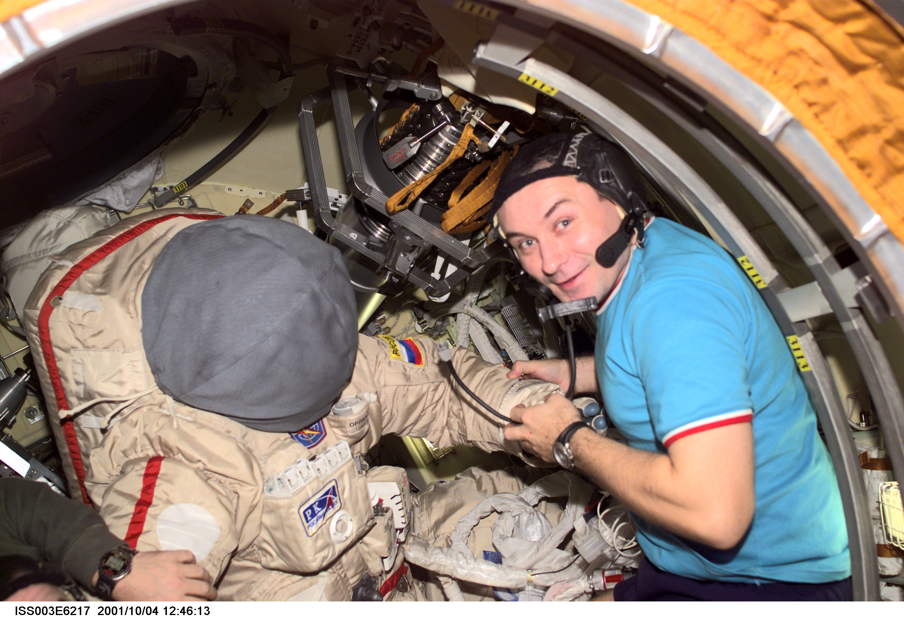 Cosmonaut Vladimir N. Dezhurov, Expedition Three flight engineer, prepares the Russian Orlan space suit for an upcoming spacewalk from the Pirs Docking Compartment on the International Space Station (ISS). Dezhurov represents Rosaviakosmos. This image was taken with a digital still camera.