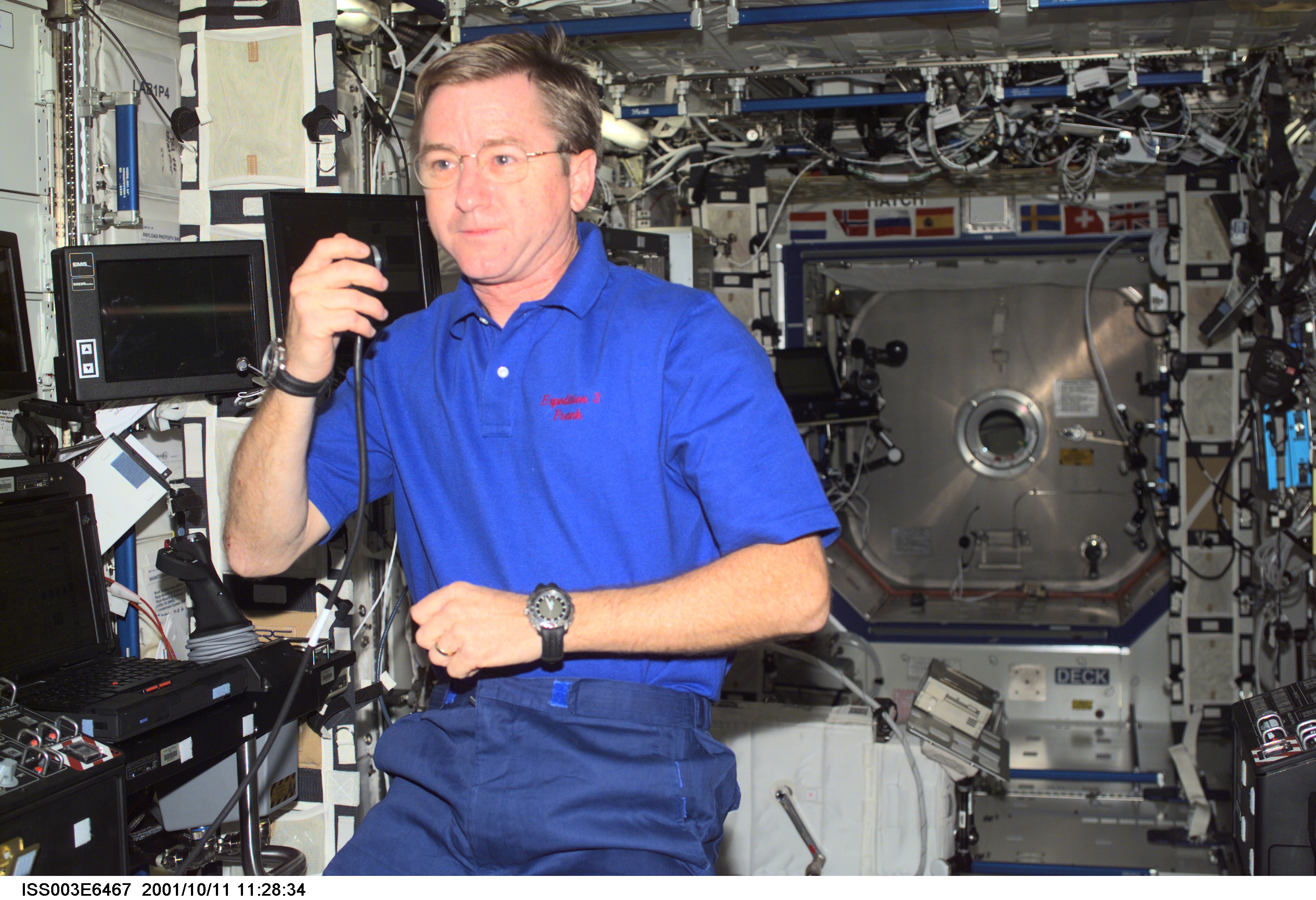 Astronaut Frank L. Culbertson, Jr., Expedition Three mission commander, talks on a microphone in the Destiny laboratory on the International Space Station (ISS). This image was taken with a digital still camera.