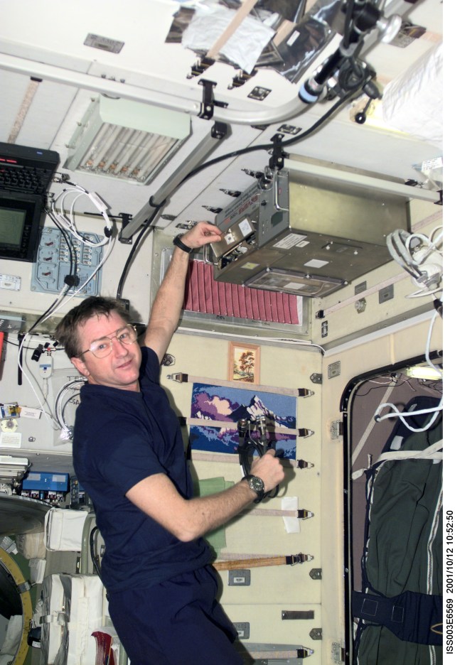 Astronaut Frank L. Culbertson, Jr., Expedition Three mission commander, works with the Total Organic Carbon Analyzer (TOCA) in the Zvezda Service Module on the International Space Station (ISS). This image was taken with a digital still camera.