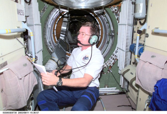 Astronaut Frank L. Culbertson, Jr., Expedition Three mission commander, uses a ham radio in the functional cargo block (FGB), or Zarya on the International Space Station (ISS). This image was taken with a digital still camera.