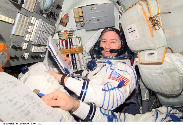 Astronaut Frank L. Culbertson, Expedition Three mission commander, wearing a Russian Sokol suit, is seated in the Soyuz spacecraft that is docked to the International Space Station (ISS). This Soyuz return vehicle will be moved from the Earth-facing port of the Zarya module for the linkup to the new Pirs Docking Compartment. The move of the Soyuz will mark the first time the new Pirs, which arrived at the station September 17, 2001, will serve as a docking port. The Soyuz will be shifted to prepare for the arrival of a new Soyuz return craft, to be launched October 21, 2001 from the Baikonur Cosmodrome in Kazakhstan. The Soyuz can serve as a crew return vehicle at the station for a maximum of about six months. This image was taken with a digital still camera.