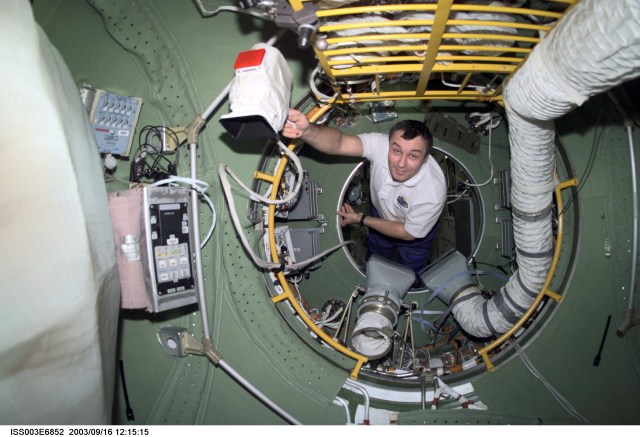 ISS003-E-6852 (October 2001) --- Cosmonaut Vladimir N. Dezhurov, Expedition Three flight engineer, floats in the pressurized adapter of the functional cargo block (FGB), or Zarya on the International Space Station (ISS). Dezhurov represents Rosaviakosmos. This image was taken with a digital still camera.