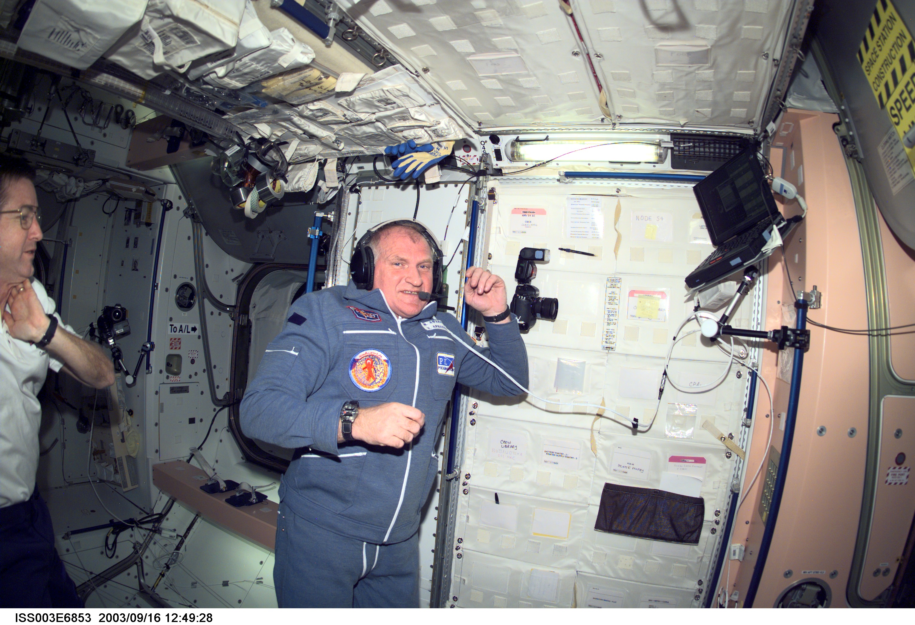 Soyuz taxi commander Victor Afanasyev and astronaut Frank L. Culbertson (partially out of frame), Expedition Three mission commander, are photographed in the Unity node on the International Space Station (ISS). Afanasyev represents Rosaviakosmos. This image was taken with a digital still camera.
