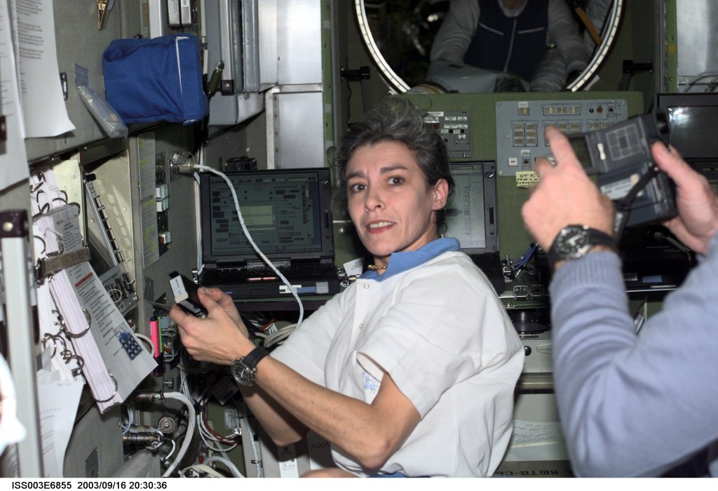 French Flight Engineer Claudie Haignere, works in the Zvezda Service Module on the International Space Station (ISS). Haignere represents ESA, carrying out a flight program for CNES, the French Space Agency, under a commercial contract with the Russian Aviation and Space Agency. This image was taken with a digital still camera.