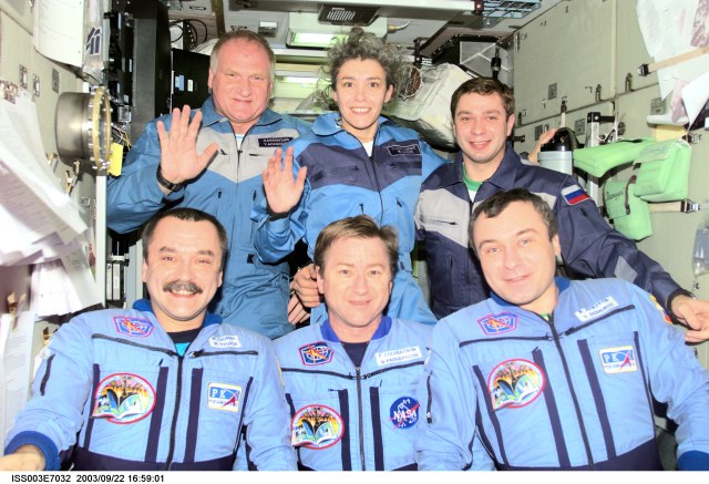 The Expedition Three crew (bottom) and the Soyuz Taxi crew assemble for a group photo in the Zvezda Service Module on the International Space Station (ISS). The Expedition Three crewmembers are astronaut Frank L. Culbertson, Jr. (center), mission commander, and cosmonauts Mikhail Tyurin (left) and Vladimir N. Dezhurov, both flight engineers. The Soyuz Taxi crewmembers are Commander Victor Afanasyev (left), French Flight Engineer Claudie Haignere, and Flight Engineer Konstantin Kozeev. Tyurin, Dezhurov, Afanasyev, and Kozeev represent Rosaviakosmos. Haignere represents ESA, carrying out a flight program for CNES, the French Space Agency, under a commercial contract with the Russian Aviation and Space Agency. This image was taken with a digital still camera.