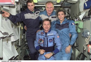 Astronaut Frank L. Culbertson, Jr. (foreground), Expedition Three mission commander, and the Soyuz Taxi crewmembers assemble for a group photo in the Zvezda Service Module on the International Space Station (ISS). From the left are Flight Engineer Konstantin Kozeev, Commander Victor Afanasyev, and French Flight Engineer Claudie Haignere. Afanasyev and Kozeev represent Rosaviakosmos, and Haignere represents ESA, carrying out a flight program for CNES, the French Space Agency, under a commercial contract with the Russian Aviation and Space Agency. This image was taken with a digital still camera.