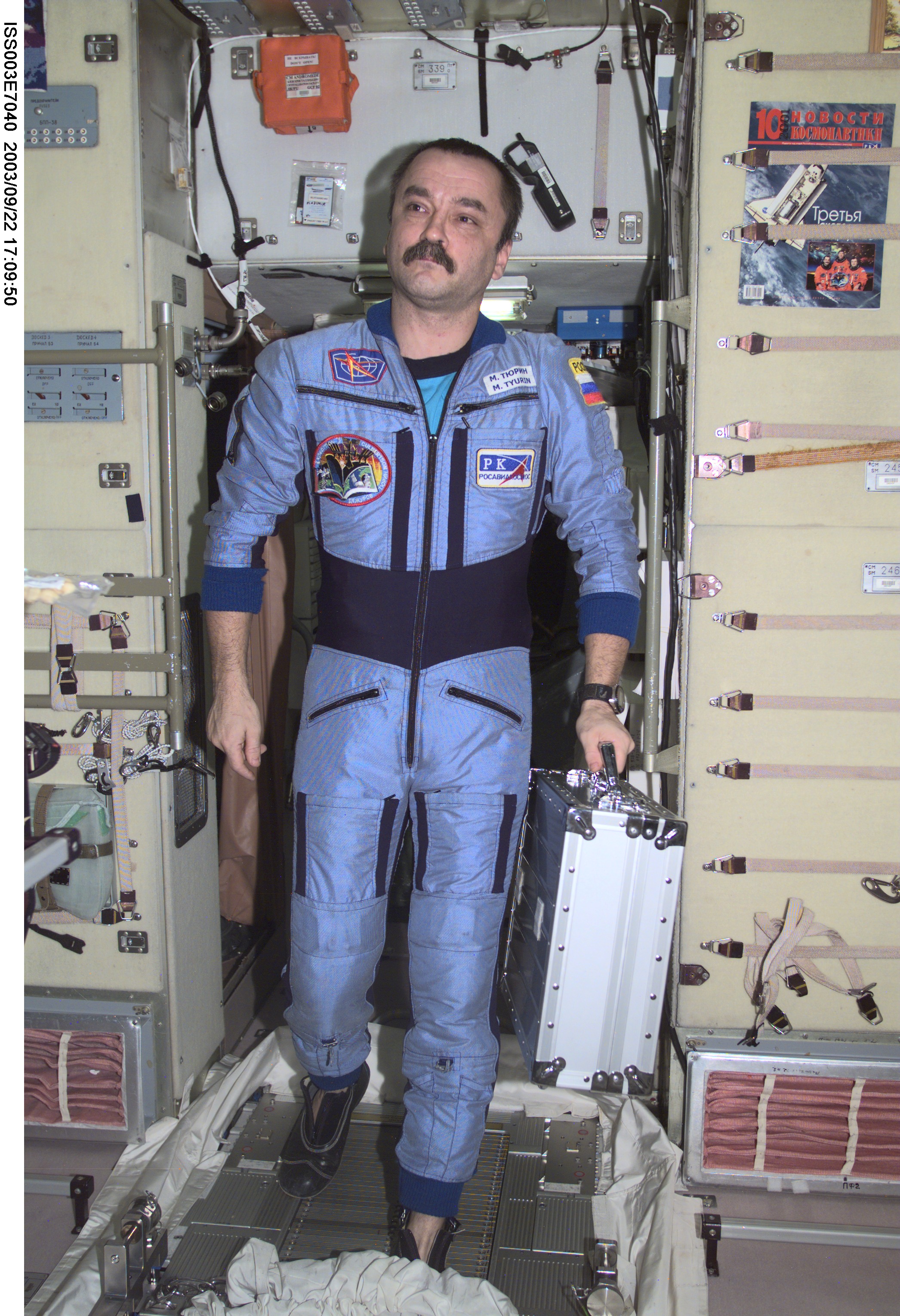 ISS003-E-7040 (October 2001) --- Cosmonaut Mikhail Tyurin, Expedition Three flight engineer representing Rosaviakosmos, moves through the Zvezda Service Module on the International Space Station (ISS). This image was taken with a digital still camera.