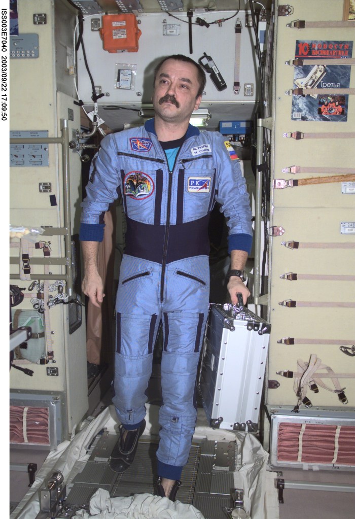 ISS003-E-7040 (October 2001) --- Cosmonaut Mikhail Tyurin, Expedition Three flight engineer representing Rosaviakosmos, moves through the Zvezda Service Module on the International Space Station (ISS). This image was taken with a digital still camera.