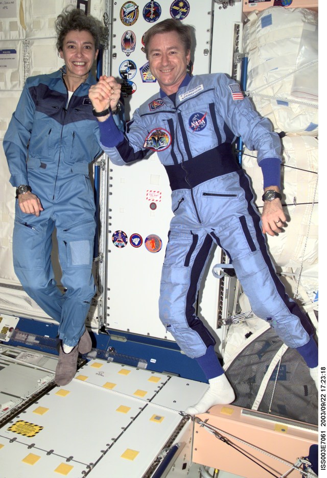 Astronaut Frank L. Culbertson, Jr. (right), Expedition Three mission commander, shakes hands with French Flight Engineer Claudie Haignere of the Soyuz Taxi crew, in the Unity node on the International Space Station (ISS). Haignere represents ESA, carrying out a flight program for CNES, the French Space Agency, under a commercial contract with the Russian Aviation and Space Agency. This image was taken with a digital still camera.