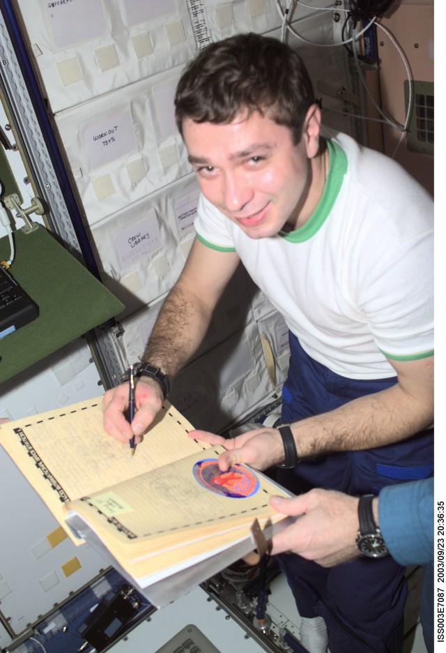 Flight Engineer Konstantin Kozeev, of the Soyuz Taxi crew, adds his name to the list of the International Space Station (ISS) visitors in the ship’s log in the Unity node. Kozeev represents Rosaviakosmos. This image was taken with a digital still camera.