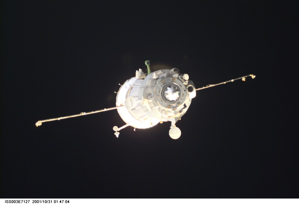 Backdropped by the blackness of space, a Soyuz spacecraft departs from the International Space Station (ISS) carrying the Soyuz taxi crew, Commander Victor Afanasyev, Flight Engineer Konstantin Kozeev and French Flight Engineer Claudie Haignere, ending their eight-day stay on the station. Afanasyev and Kozeev represent Rosaviakosmos, and Haignere represents ESA, carrying out a flight program for CNES, the French Space Agency, under a commercial contract with the Russian Aviation and Space Agency. This image was taken with a digital still camera.