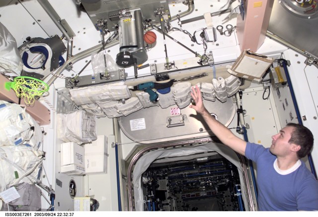 Cosmonaut Vladimir N. Dezhurov, Expedition Three flight engineer, takes a break from his duties, as he plays with a miniature basketball and net in the Unity node on the International Space Station (ISS). Dezhurov represents Rosaviakosmos. This image was taken with a digital still camera.