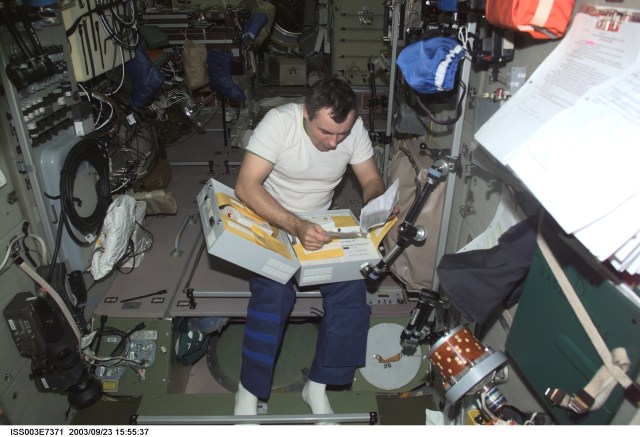 Cosmonaut Vladimir N. Dezhurov, Expedition Three flight engineer representing Rosaviakosmos, works in the Zvezda Service Module on the International Space Station (ISS). This image was taken with a digital still camera.