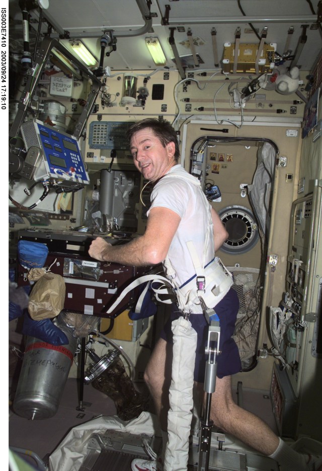 Astronaut Frank L. Culbertson, Jr., Expedition Three mission commander, exercises on a treadmill in the Zvezda Service Module on the International Space Station (ISS). This image was taken with a digital still camera.