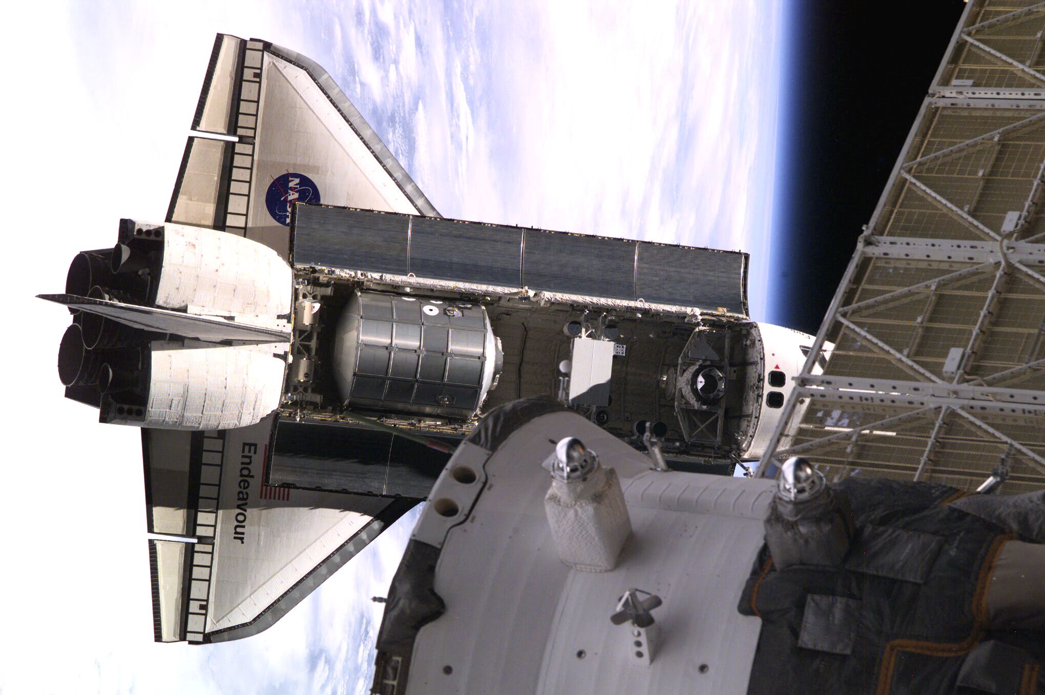 Backdropped against Earth's horizon, the Space Shuttle Endeavour, controlled by the flight crew of STS-108, rapidly approaches the International Space Station (ISS). Among other activities Endeavour's mission will include the change out of the station crews. The image was recorded with a digital still camera.