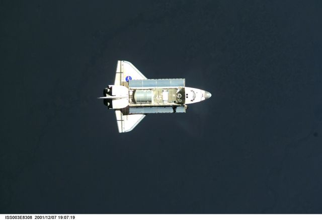 The Space Shuttle Endeavour, controlled by the flight crew of STS-108, is surrounded by darkness as it approaches the International Space Station (ISS). The Raffaello logistics module that is being brought up to the orbiting outpost is clearly visible in Endeavour's cargo bay. Among other activities the Endeavour's mission will include the change out of the station crews. The image was recorded with a digital still camera.