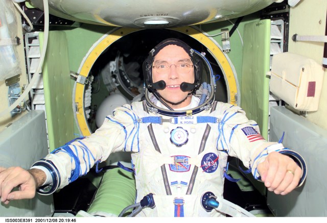 Astronaut Carl E. Walz, Expedition Four flight engineer, wearing a Russian Sokol suit, is photographed in the functional cargo block (FGB), or Zarya on the International Space Station (ISS). The image was taken with a digital still camera.
