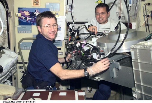 Astronauts Frank L. Culbertson, Jr. (left), Expedition Three mission commander, and Daniel W. Bursch, Expedition Four flight engineer, work in the Zvezda Service Module on the International Space Station (ISS). The image was taken with a digital still camera.