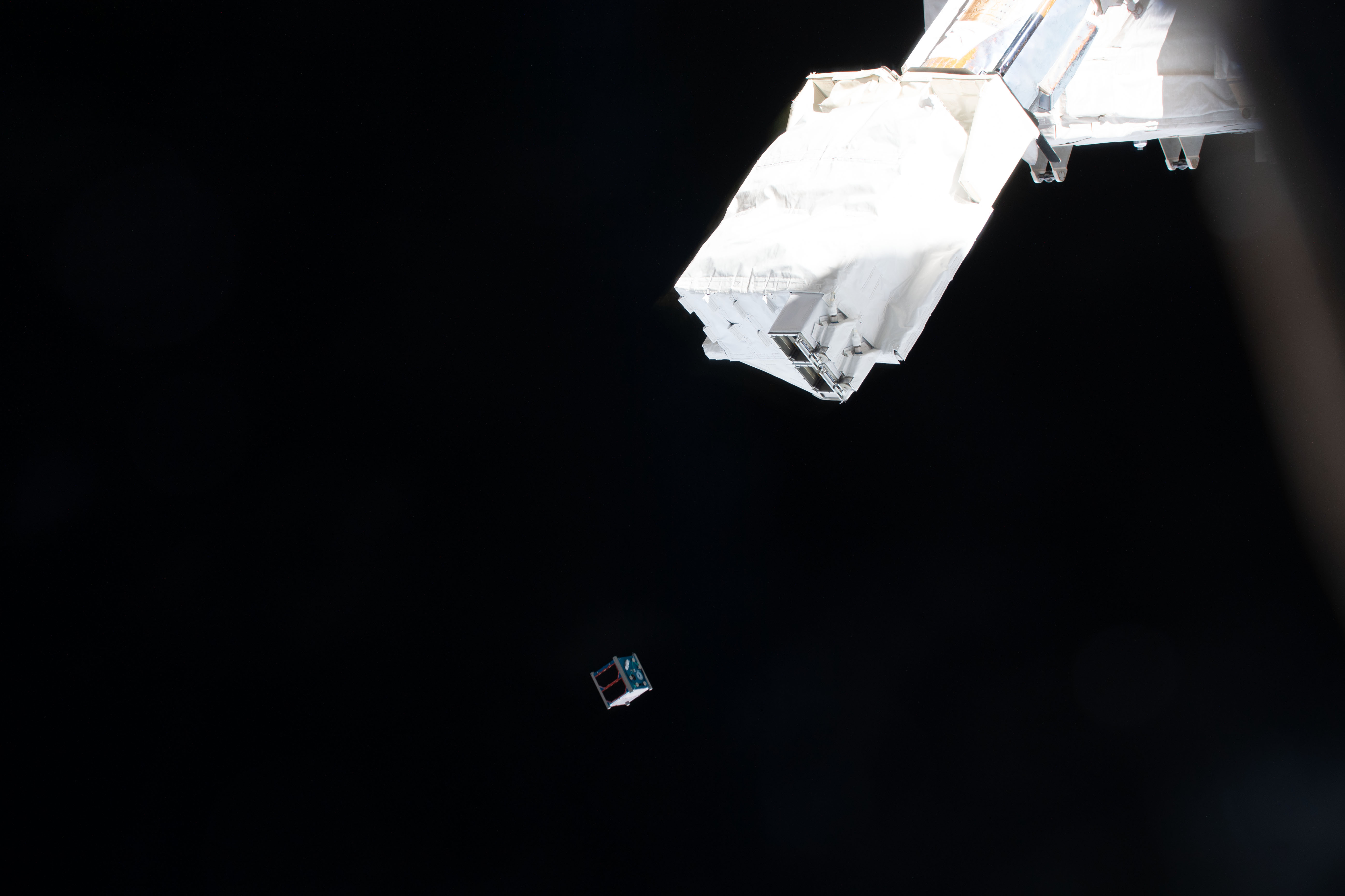 The Clark sat-1 CubeSat is deployed from a small satellie deployer in the grips of the Japanese robotic arm attached to the Kibo laboratory module. Clark sat-1, launched to the Interational Space Station aboard the SpaceX Dragon cargo spacecraft, was developed by students at Clark Next High School in Tokyo, Japan, and its primary mission is to transmit voice and imagery data to ground control stations on Earth.