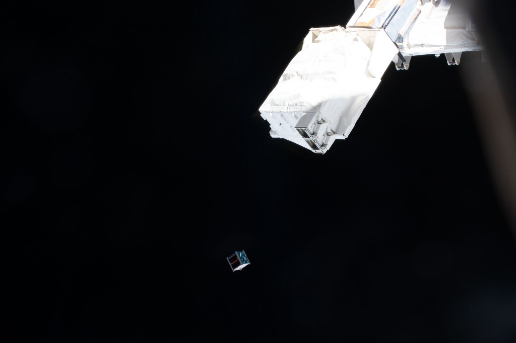 The Clark sat-1 CubeSat is deployed from a small satellie deployer in the grips of the Japanese robotic arm attached to the Kibo laboratory module. Clark sat-1, launched to the Interational Space Station aboard the SpaceX Dragon cargo spacecraft, was developed by students at Clark Next High School in Tokyo, Japan, and its primary mission is to transmit voice and imagery data to ground control stations on Earth.