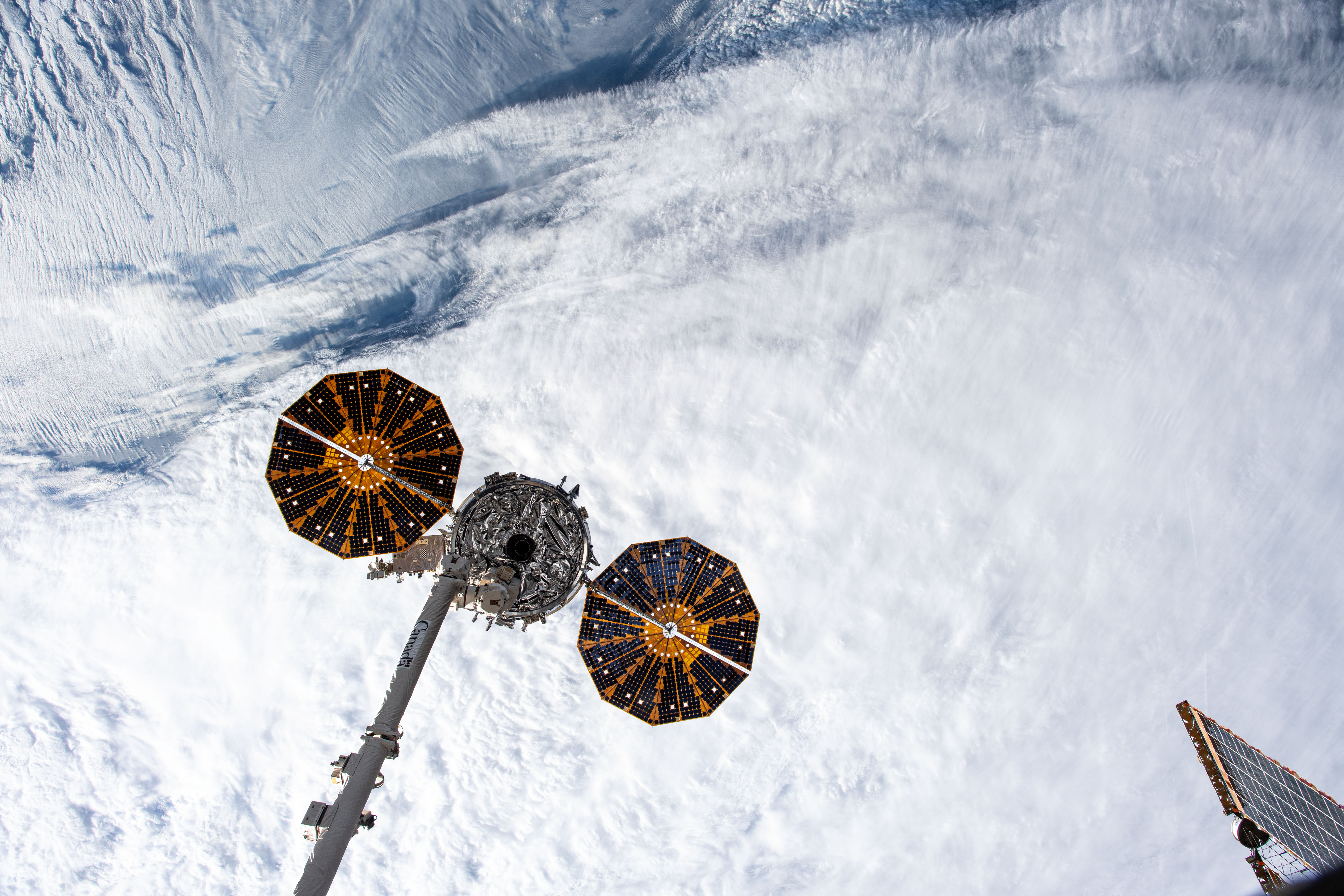This view from the main window on the International Space Station's cupola shows Northrop Grumman's Cygnus space freighter in the grip of the Canadarm2 robotic arm moments before its release. The orbital complex was soaring 260 miles above the Atlantic Ocean off the Canadian island of Newfoundland at the time of this photograph.