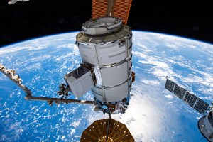 Northrop Grumman's Cygnus space freighter is pictured in the grip of the Canadarm2 robotic arm shortly after it was detached from the Unity module. The orbital complex was soaring 260 miles above the island archipelago of Seychelles in the Indian Ocean at the time of this photograph.