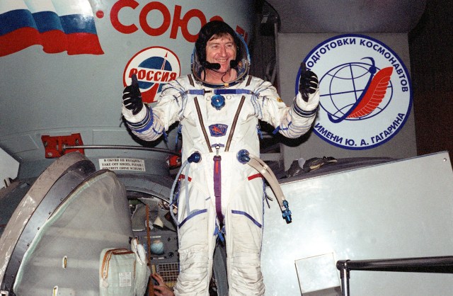 Using both thumbs to signal success, astronaut Frank L. Culbertson. Jr., emerges from a training session in the nearby Soyuz trainer. Culbertson, currently visiting the Gagarin Cosmonaut Training Center in Russia, is in training as commander for Expedition Three. He was named to that position in September of this year.