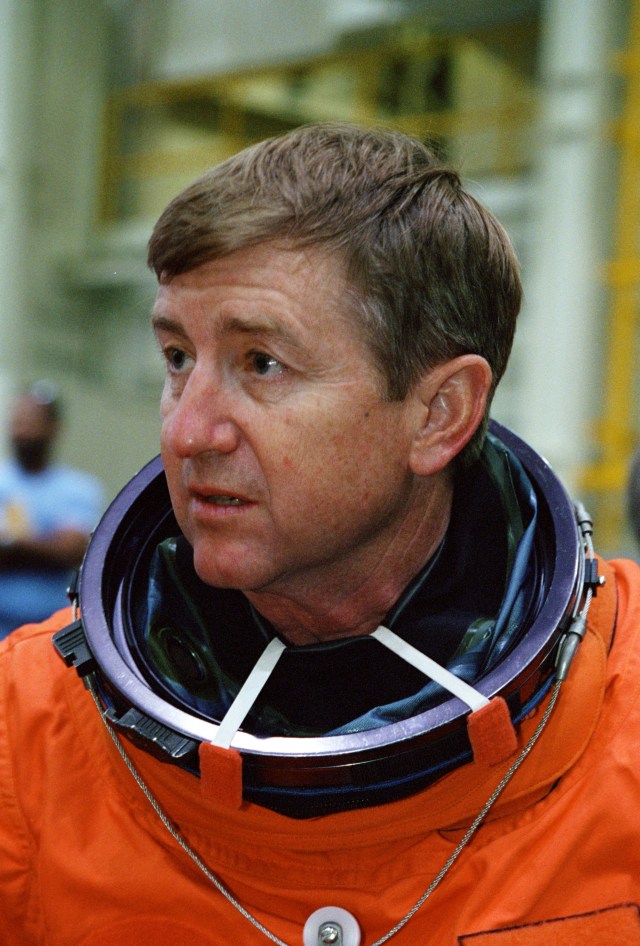 Astronaut Frank L. Culbertson, Jr., Expedition Three commander, attired in a training version of the shuttle launch and entry garment, is photographed prior to a mission training session in the Systems Integration Facility at Johnson Space Center (JSC). Culbertson, minutes later, was seated along with his cosmonaut crew mates on the mid deck of one of the high fidelity trainers/mockups. The Expedition Three crew is scheduled to launch aboard the Space Shuttle Discovery this summer to begin a lengthy stay onboard the International Space Station (ISS).